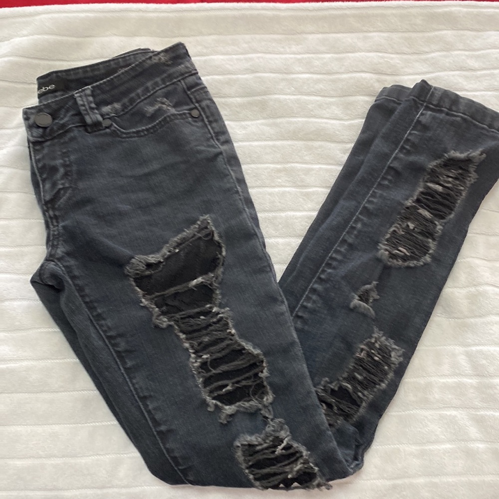 Bebe black distressed cut jeans.